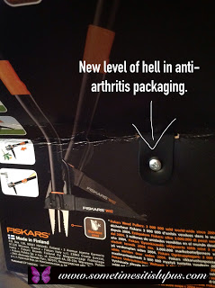 Image, packaging of product designed to make it easy to pull weeds, with arrow pointing to a screw holding the packaging to the product..  Text New level of hell in anti-arthritis packaging.