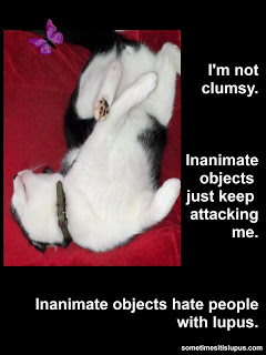 Image: cat on its back with its paws up in the air. Text: I'm not clumsy. Inanimate objects just keep attacking me. Inanimate objects hate people with lupus.
