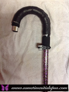Image: Walking stick handle, covered with tennis racquet handle tape, and with gadget for hanging on table.
